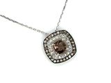 a close up of a necklace with a brown and white diamond