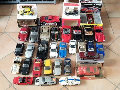 a lot of toy cars that are sitting on the floor