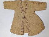 a small knitted sweater on a white surface