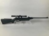 a rifle on a stand with a scope on it