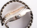 a close up of a watch on a white surface