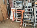 a lot of chairs and ladders in a garage