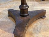 an image of a wooden table with a metal base on a wooden floor