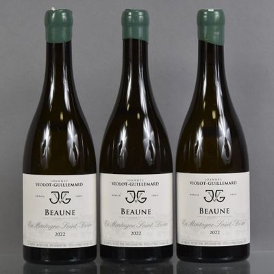 three bottles of wine are lined up on a table