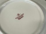 a white plate with a red and black design on it