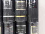 a lot of black and gold books stacked on top of each other