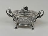 an antique silverplated bowl with a lid and handles