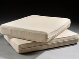 two pillows sitting on top of each other on a table