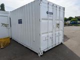 a white container sitting in the middle of a parking lot