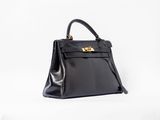 un sac à main en cuir noir sur fond blanc