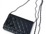 a close up of a chanel purse with a chain around it