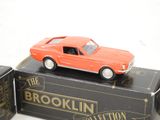 an orange toy car sitting on top of a box
