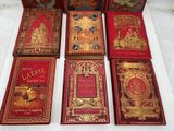 four books are sitting on a table with a white table cloth
