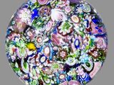 a picture of a glass paperweight with a lot of flowers on it