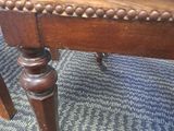 an image of a wooden chair with a brown leather seat