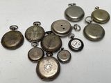 many different types of pocket watches on the table