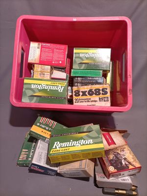 a pink box full of cigarettes and other items on a table