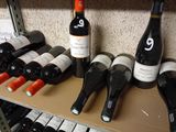 several bottles of wine are lined up on a shelf in a wine shop