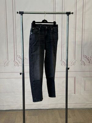 an image of a pair of jeans hanging on a clothes rack