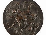une médaille antique en bronze représentant un homme à cheval et une femme à cheval