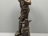 bronze statue of a boy with a dog on a marble base