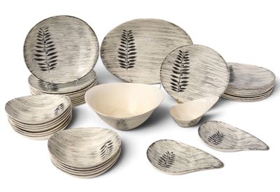 a lot of plates and bowls that are sitting on a table