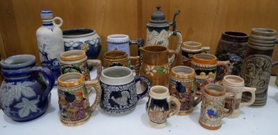 many different types of beer mugs sitting on a table