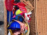 a wicker basket full of toys on the floor