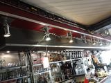 a picture of a bar with a lot of bottles on the shelves