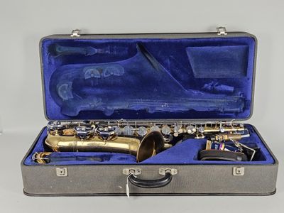 a silver case with a saxophone in it on a white surface