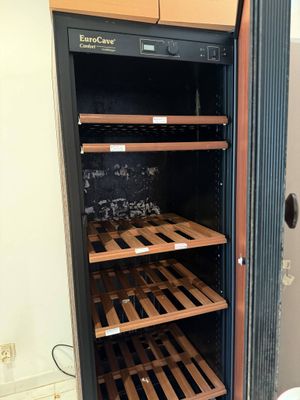 a wine cooler in the corner of a room
