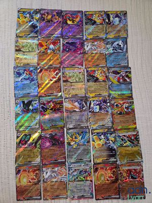 a close up of a pile of pokemon cards on a table