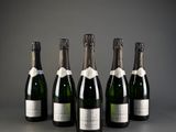 six bottles of champagne are lined up in a row