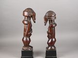 pair of carved wooden figures of a man and a woman