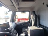 a view of the inside of a truck from the driver ' s seat