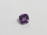 a cushion cut amethorate gems on a white surface