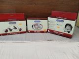 three boxes of baby products sitting on top of a bed