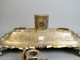 a silver plate with a candle holder on it