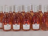 six bouteilles de vin sont alignées sur une table