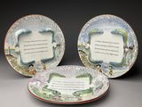 trois assiettes sur lesquelles est inscrit un poème, disposées les unes à côté des autres
