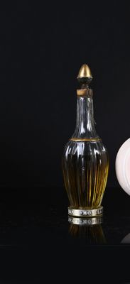 a bottle of perfume next to a small bottle of perfume