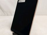 a close up of a cell phone on a stand on a white surface