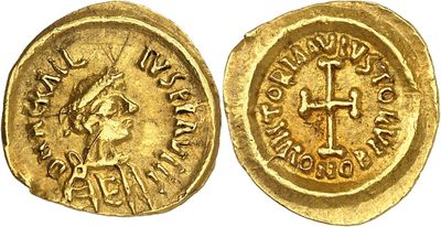 a gold coin with an image of a woman and a cross on it