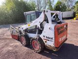 a picture of a ski - loader parked in a lot