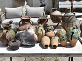 many vases on a table outside on the patio
