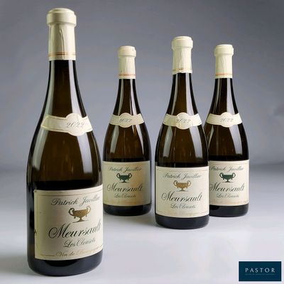 four bottles of wine are lined up on a table