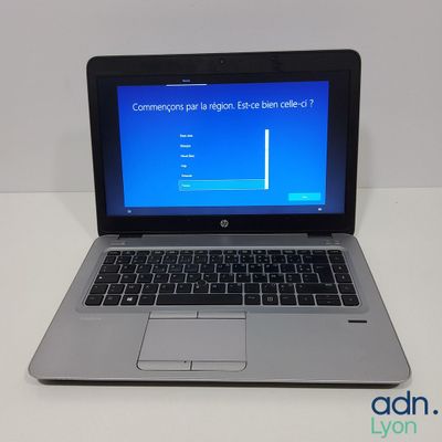 a laptop that is sitting on a table with a blue screen