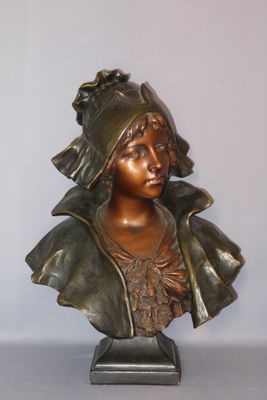 bronze bust of a woman with a hat on a stand