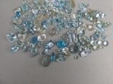 a pile of blue and white glass beads on a table