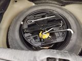 a close up of a car ' s steering wheel with a wren on it